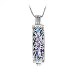 A silver cylindrical pendant with intricate filigree design reveals a colorful, iridescent interior—a discreet way to cherish memories, often chosen for pet cremation in Harris County, TX. The pendant hangs from a thin, silver chain.