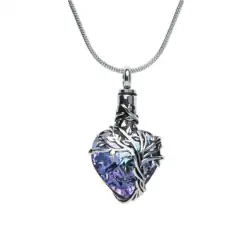 A silver necklace with a heart-shaped, blue-violet crystal pendant wrapped in an ornate, silver vine design—an elegant keepsake, perfect for honoring cherished memories such as TX or pet cremation Harris County remembrances.