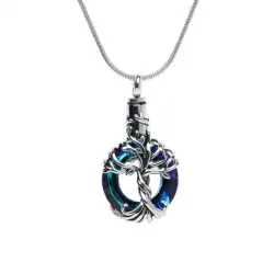 A silver necklace with a circular blue-green crystal pendant, wrapped in intricate silver branches, hanging from a thin chain—an elegant keepsake inspired by TX pet cremation Harris County services.