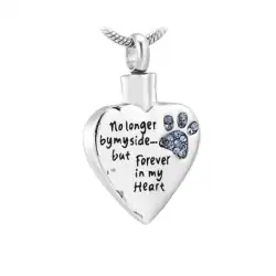 A silver heart-shaped pendant engraved with a paw print and the words "No longer by my side... but forever in my heart," this piece offers comfort to those seeking pet cremation in Harris County, TX. The pendant hangs gracefully from a silver chain.