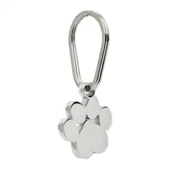 A shiny silver keychain shaped like a paw print, attached to a simple oval-shaped metal keyring—an ideal keepsake for those seeking pet cremation in Harris County, TX.