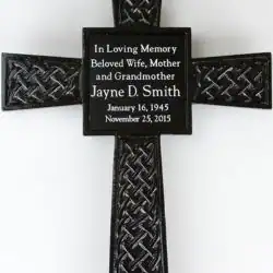 A black decorative cross features an inscription in memory of Jayne D. Smith, a beloved wife, mother, and grandmother from TX, with birth and death dates: January 16, 1945 – November 25, 2015.