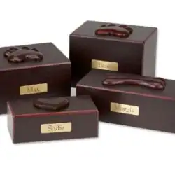Four dark wooden pet urns of different sizes are shown, each with a nameplate and a raised paw print or bone decoration on top, honoring pets with dignity for families seeking pet cremation in Harris County, TX. Set against a white background.