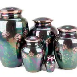 Five iridescent urns of varying sizes with metallic finishes and raised paw print designs are grouped together, ideal for pet cremation in Harris County, TX, and displayed against a white background.
