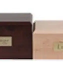 Two wooden boxes, one dark and one light, sit side by side. Each box has a small engraved metal plaque on the front, symbolizing dignified pet cremation in Harris County, TX.