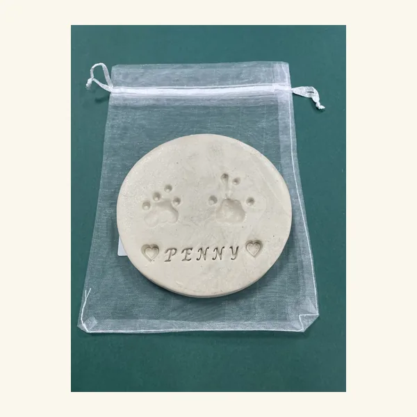Clay paw print keepsake with a pet's name pressed into it