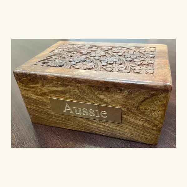 Complimentary wooden urn with an engraved brass nameplate