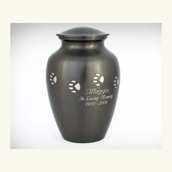 Brass urn engraved with paw prints and a pet's name